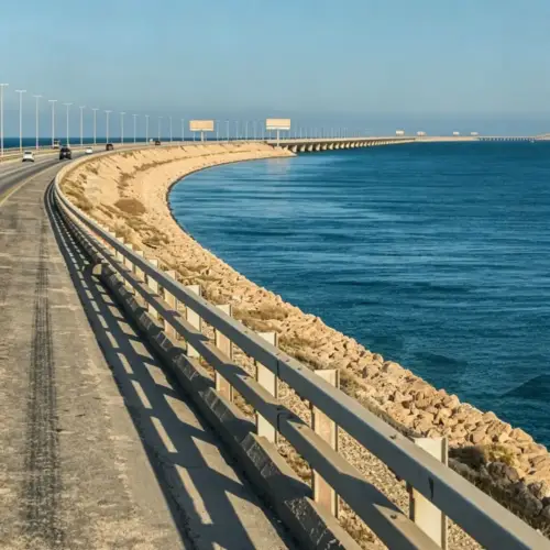 Standard W-beam guardrail installed along a waterfront bridge approach