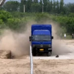 Truck and bus undergoing full-scale guardrail crash tests at a road safety test facility