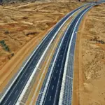 Aerial view of a divided highway through arid terrain