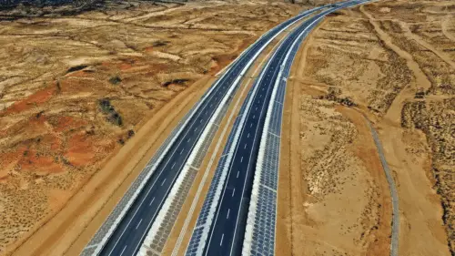 Aerial view of a divided highway through arid terrain