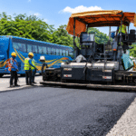 Road resurfacing works with an asphalt paver and road crew