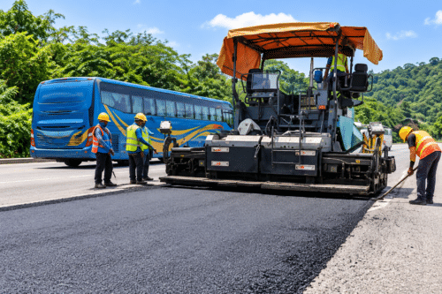 Road resurfacing works with an asphalt paver and road crew