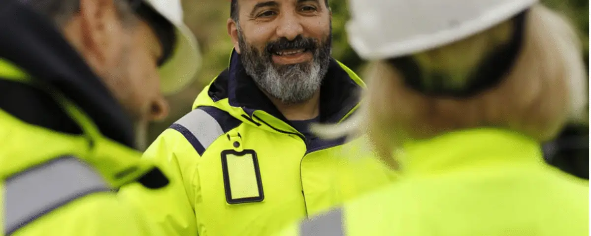Road construction workers wearing high-visibility safety clothing at a highway work zone