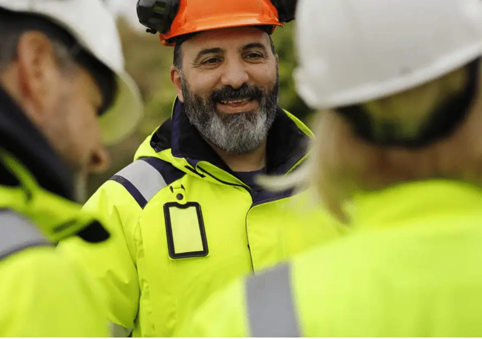 Road construction workers wearing high-visibility safety clothing at a highway work zone