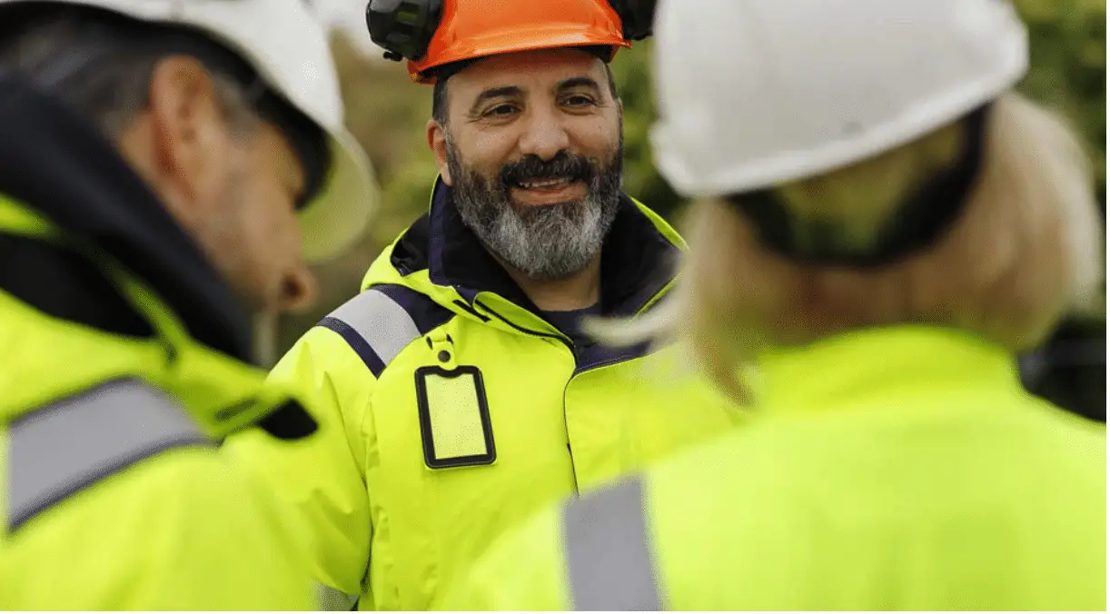 Road construction workers wearing high-visibility safety clothing at a highway work zone